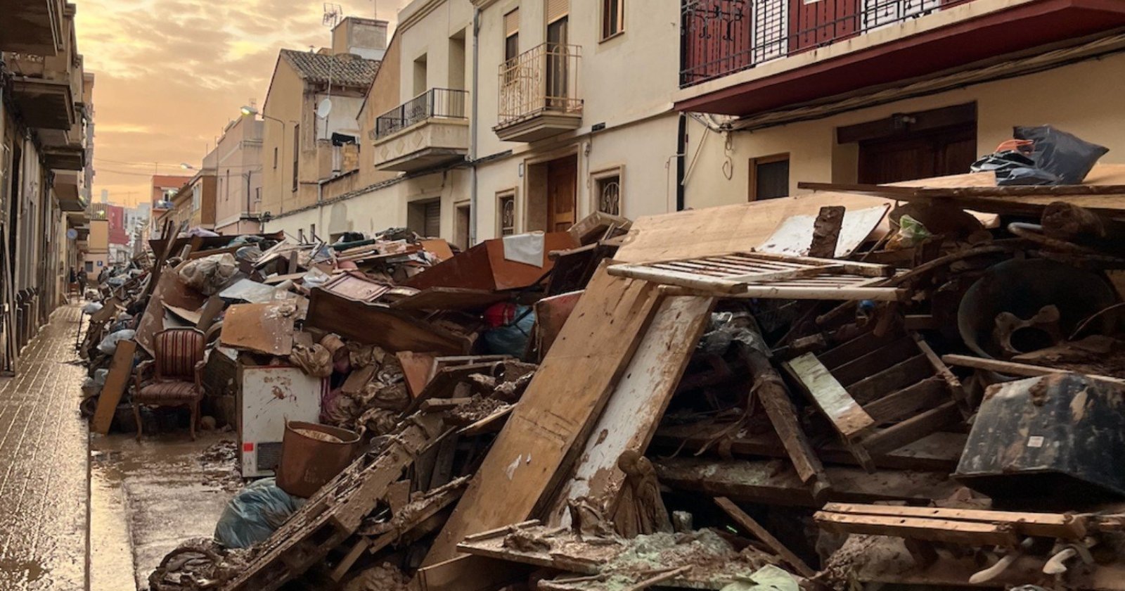 Estate of detached houses. Discarded, flood-damaged furniture takes up the entire width of the street