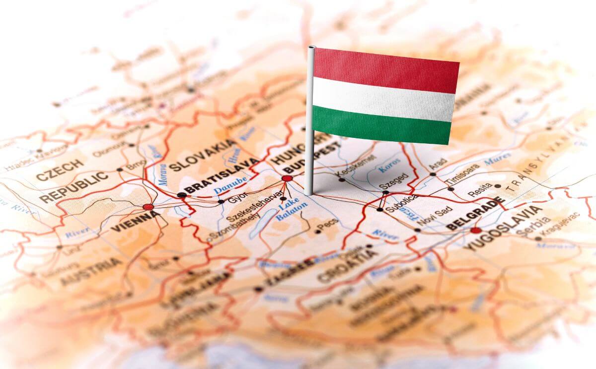 The graphic shows the Hungarian flag stuck into the outline of Hungary on a map of Europe.