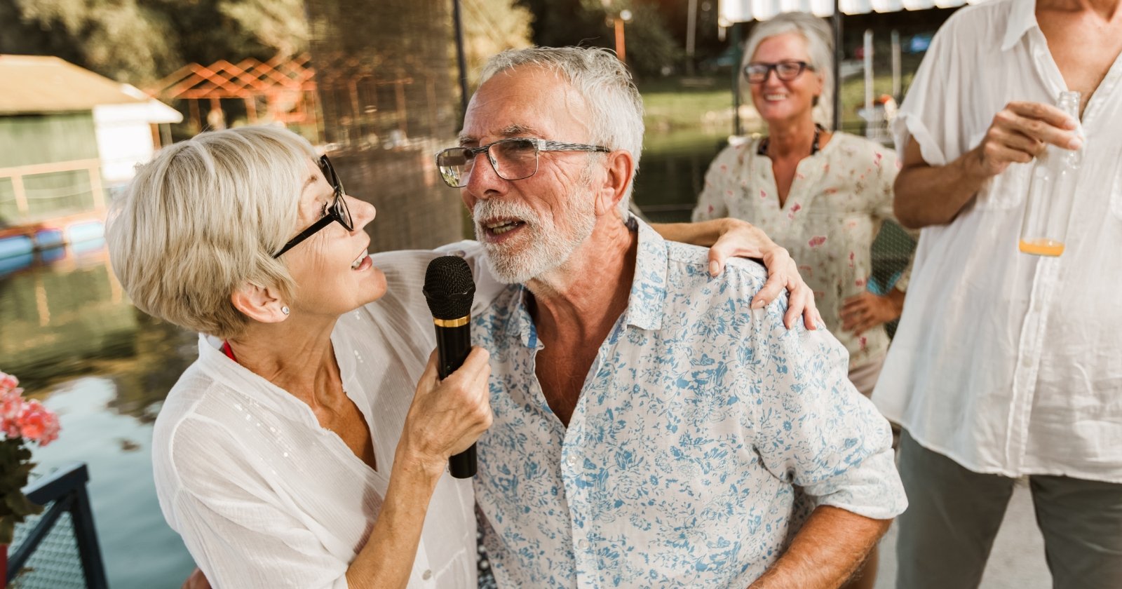 The photo shows seniors with a microphone participating in an event.